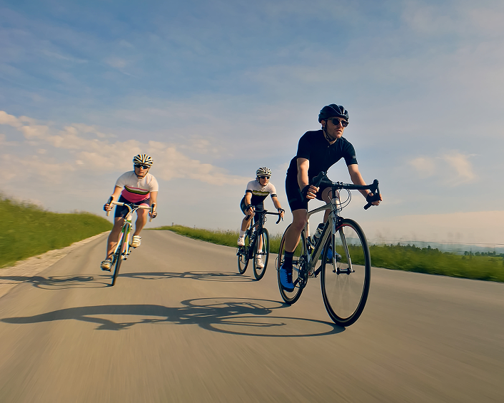 three guys riding a road bicyle