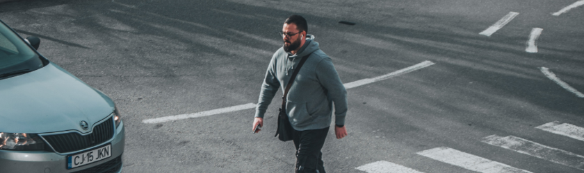 a man crossing a pedestrian lane